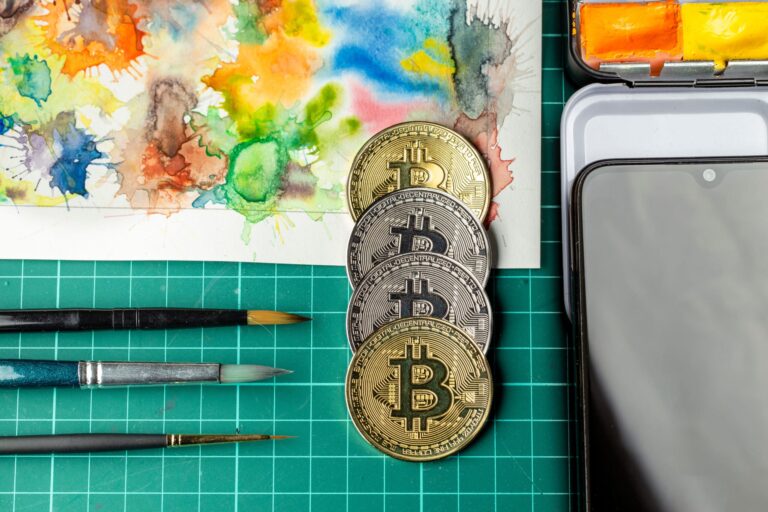 Work surface with paintbrushes and coins representing bitcoin